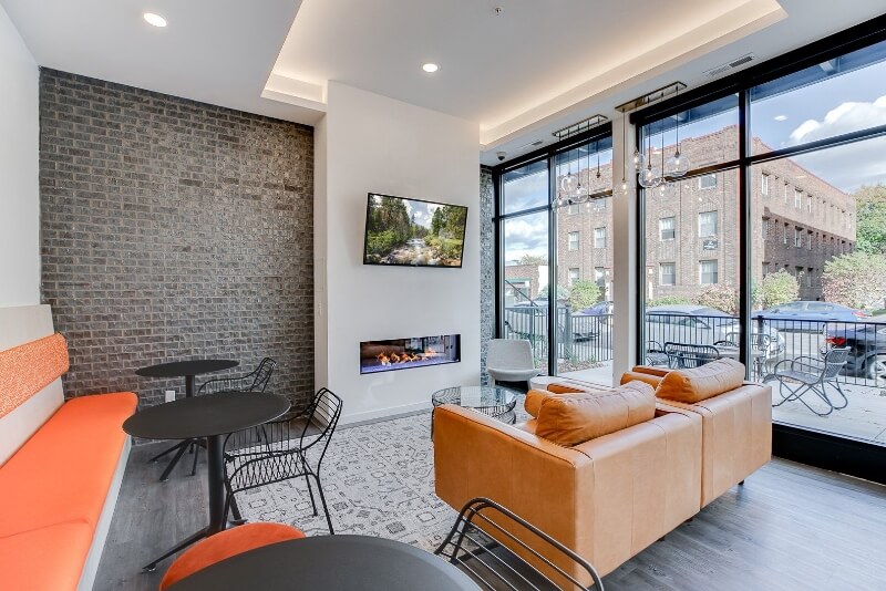 the community seating area with a large tv and a huge window to the street