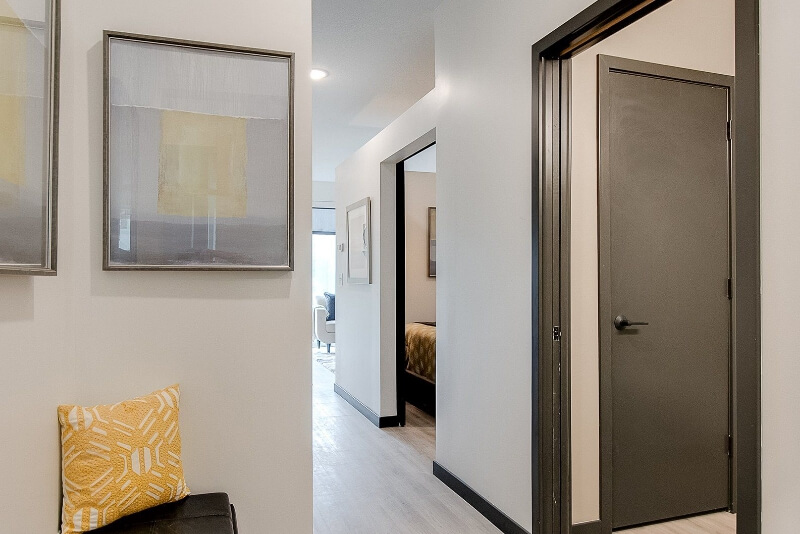 an apartment hallway looking at the bedrooms