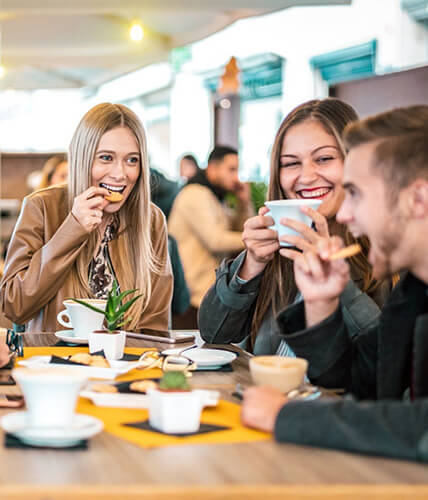 a group of friends out to eat, smiling and having a good time