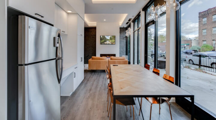 the community area with kitchen appliances and a large table